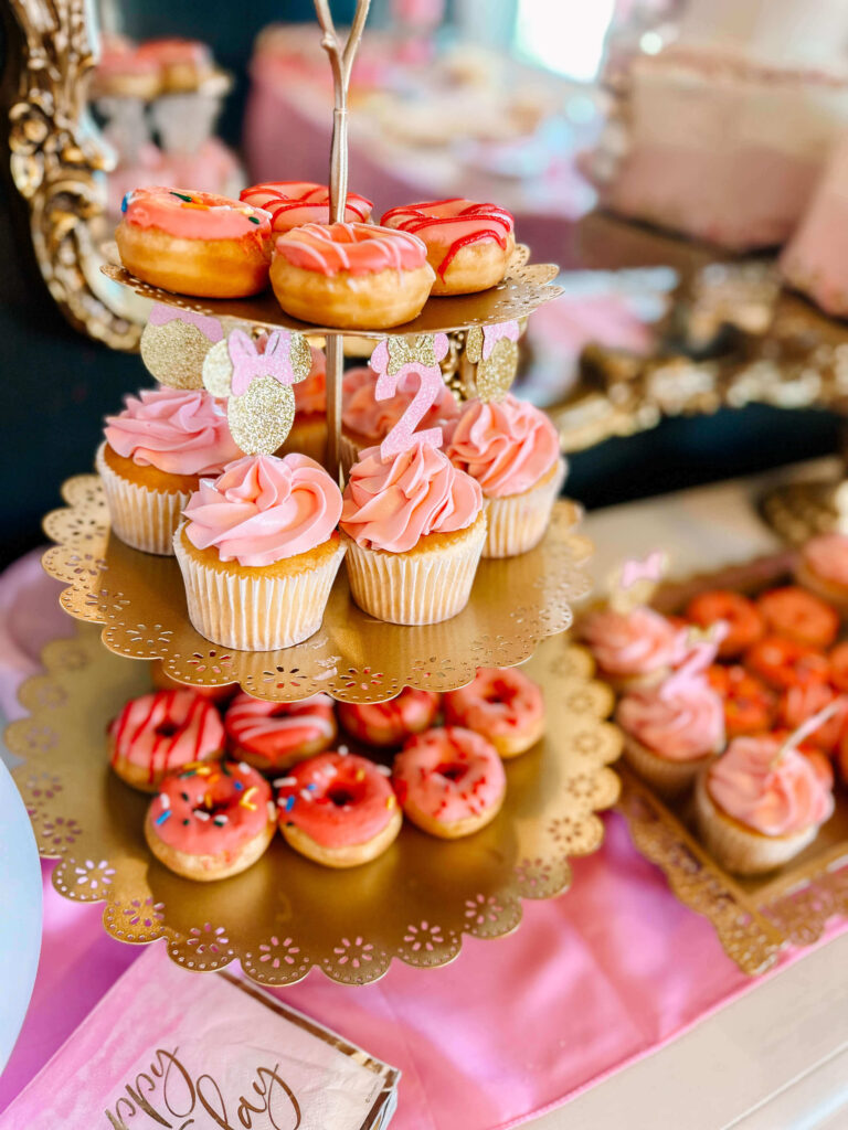 Pink cupcakes on cupcake stand with Minnie Mouse toppers