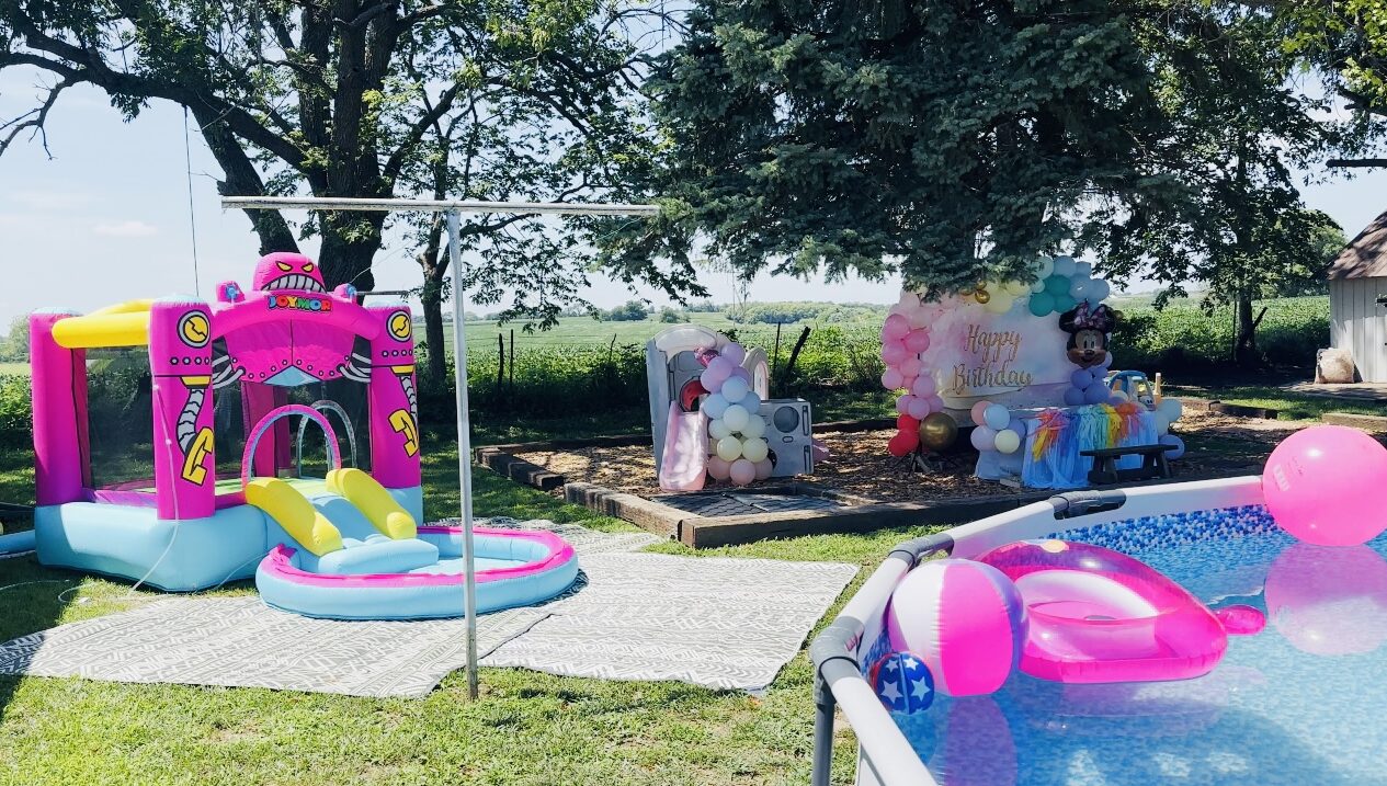 Birthday play area outside with pool and bounce house