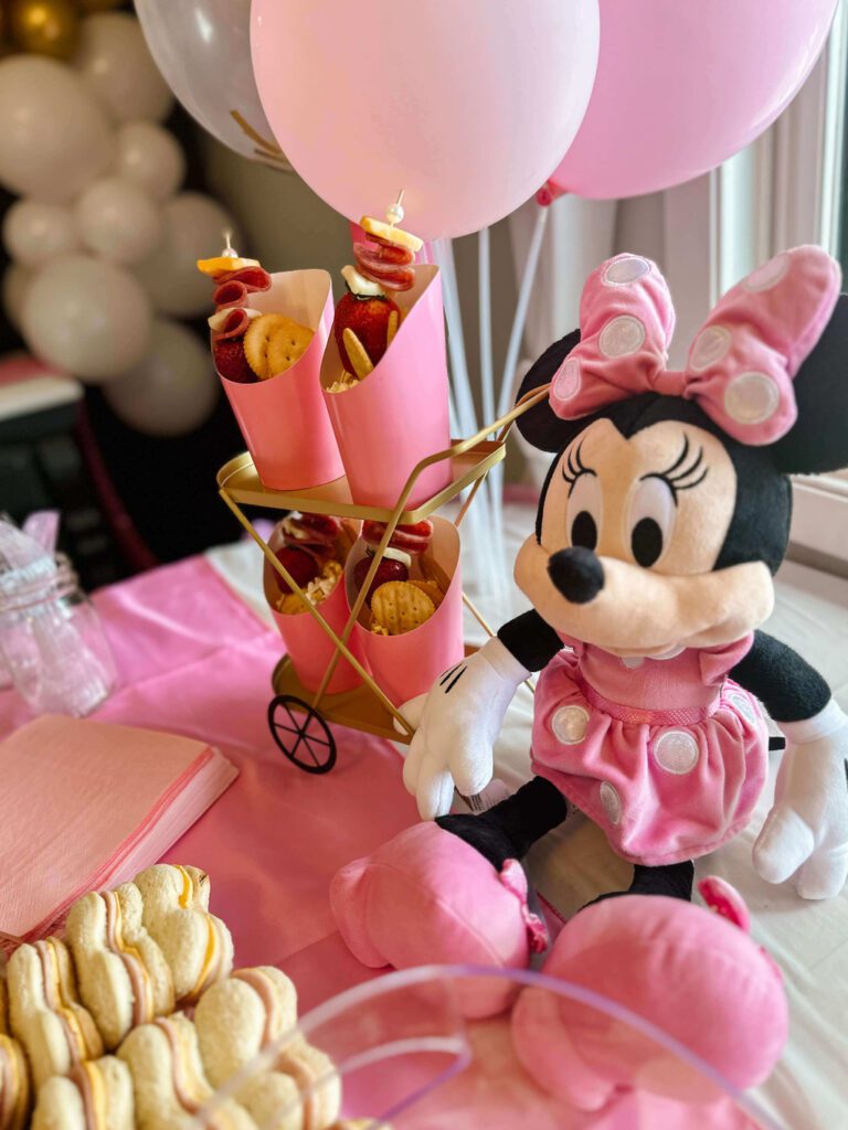 Minnie mouse plush doll on food table